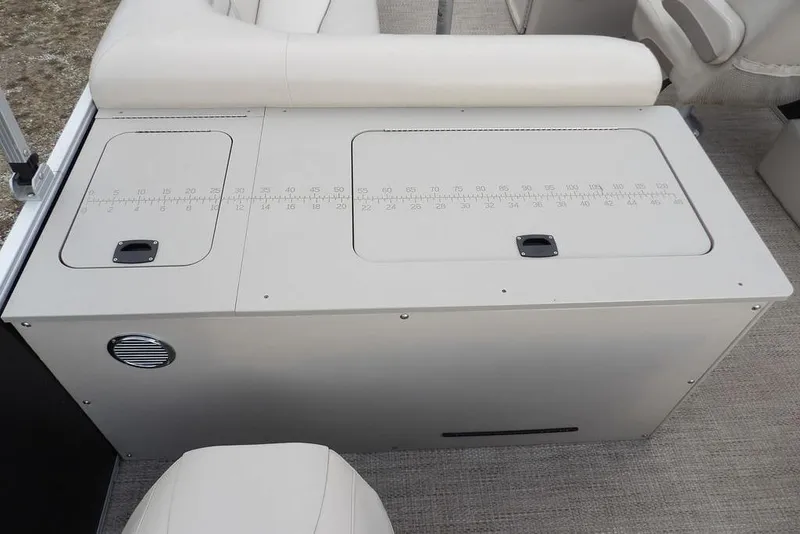 Slide: The Image of 2018 Bennington 23SF boat seating with integrated storage and measurement markings. - 55