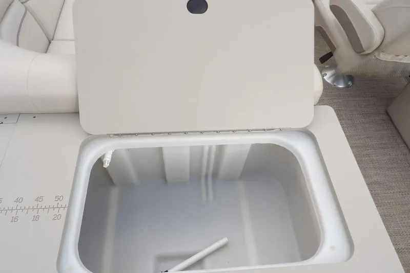 Slide: The Image of Open storage compartment on 2018 Bennington 23SF boat, featuring a spacious interior. - 56