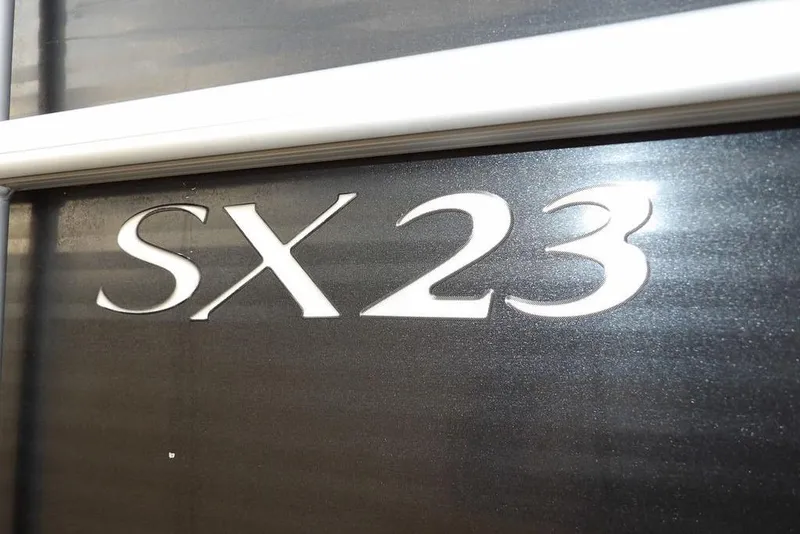 Slide: The Image of Close-up of 2018 Bennington 23SF model with SX23 lettering on dark surface. - 61