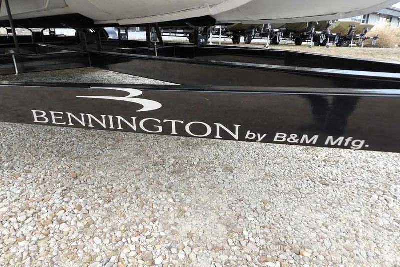 Slide: The Image of 2018 Bennington 23SF boat trailer by B&M Manufacturing on gravel surface. - 62