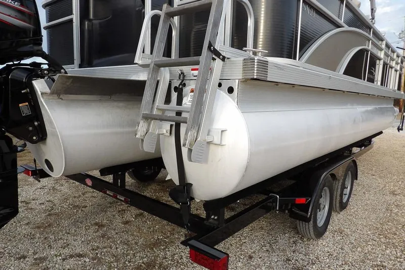 Slide: The Image of 2018 Bennington 23SF pontoon boat on trailer, rear view with ladder and motor. - 63