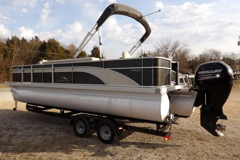 Slide: The Image of 2018 Bennington 23SF pontoon boat with Mercury outboard motor on a trailer. - 68