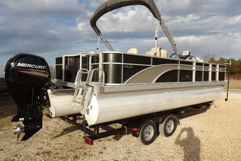 Slide: The Image of 2018 Bennington 23SF pontoon boat with Mercury outboard motor on trailer. - 8