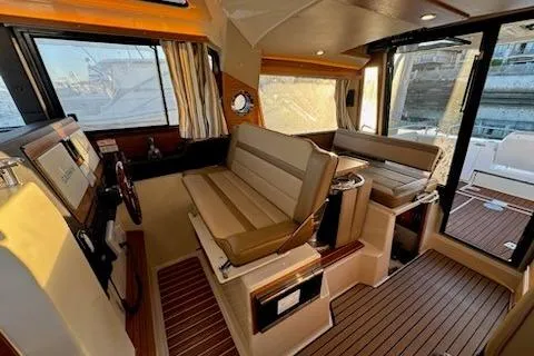Slide: The Image of 2025 Ranger Tug R-29 CB Luxury Edition interior with elegant seating and wood accents. - 10