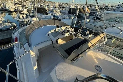 Slide: The Image of 2025 Ranger Tug R-29 CB Luxury Edition at marina, showcasing helm and seating area. - 15