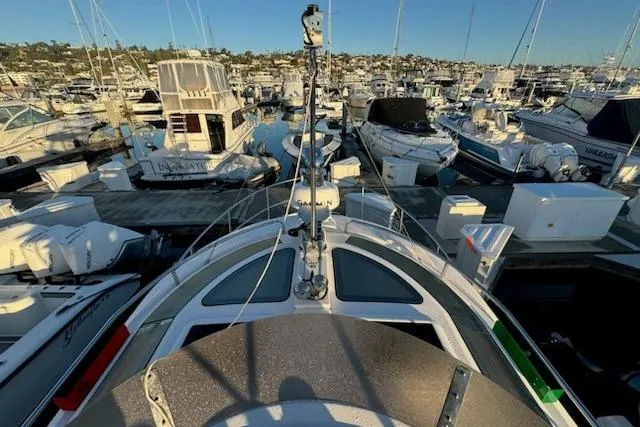 Slide: The Image of 2025 Ranger Tug R-29 CB Luxury Edition docked in a bustling marina. - 17