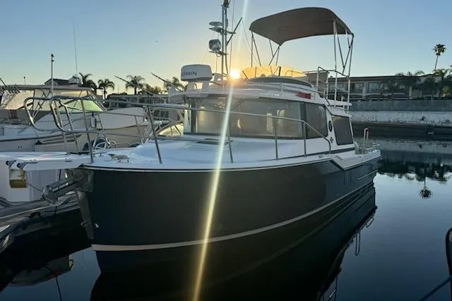 Slide: The Image of 2025 Ranger Tug R-29 CB Luxury Edition docked at sunset, showcasing sleek design and modern features. - 3
