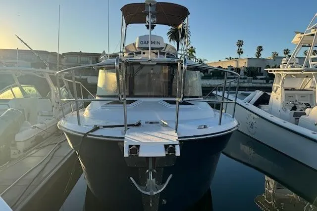 Slide: The Image of 2025 Ranger Tug R-29 CB Luxury Edition docked at marina, front view. - 4