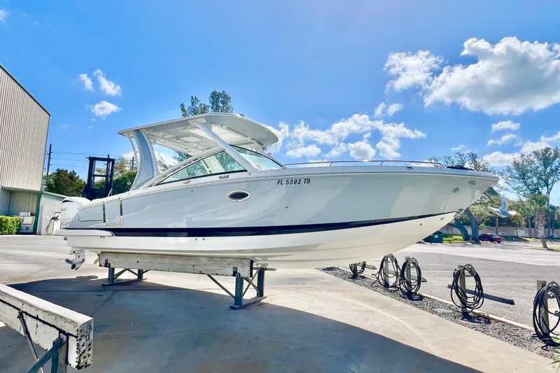 The Image of 2023 Chaparral 300 OSX boat on display under a clear blue sky. - 0