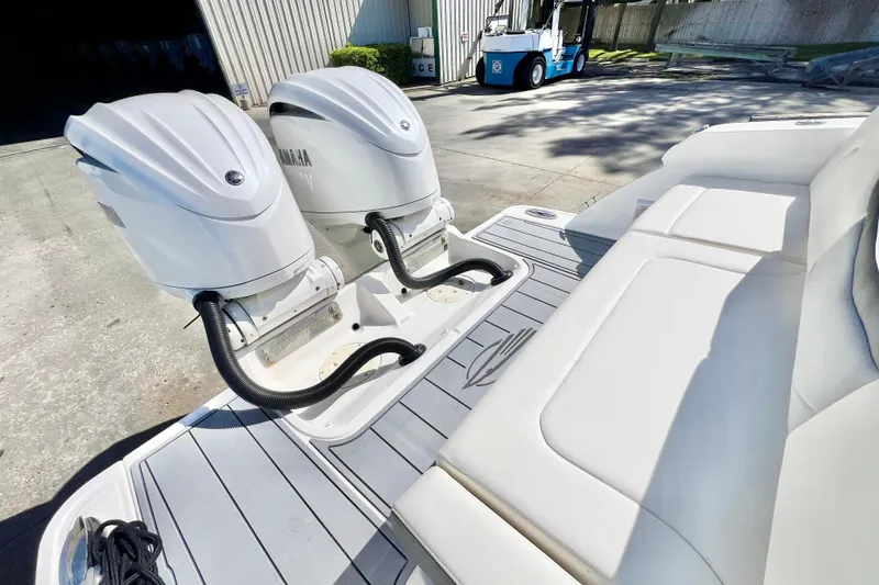 Slide: The Image of 2023 Chaparral 300 OSX boat with dual Yamaha outboard engines, docked outdoors. - 10
