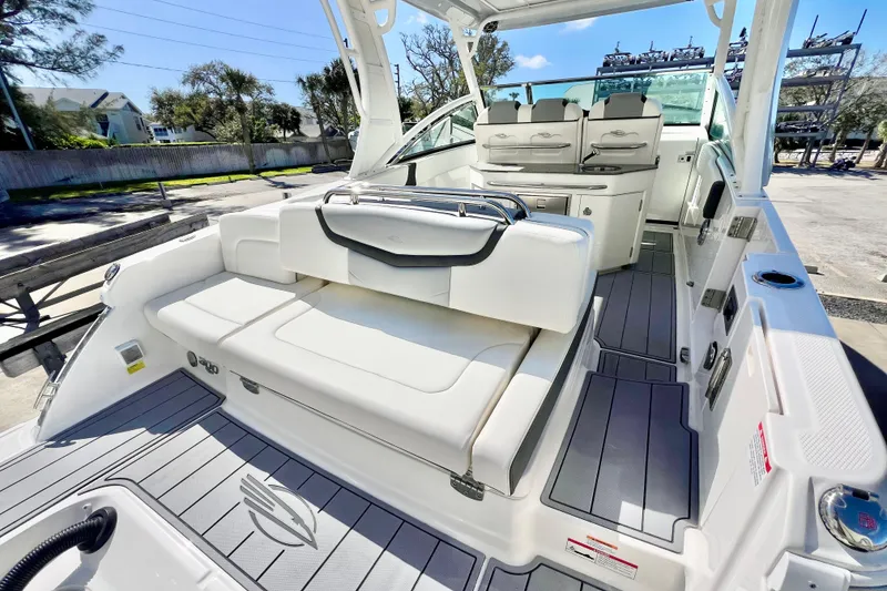 Slide: The Image of 2023 Chaparral 300 OSX boat interior with sleek seating and modern design. - 11