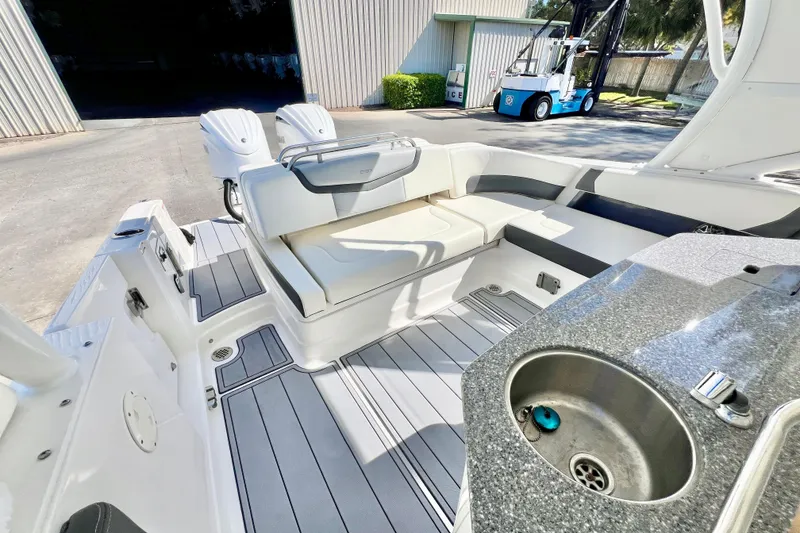Slide: The Image of Interior of 2023 Chaparral 300 OSX with seating area and sink. - 17