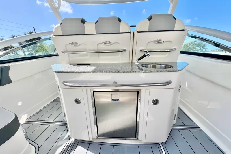Slide: The Image of 2023 Chaparral 300 OSX boat interior with sleek kitchenette and modern design. - 18