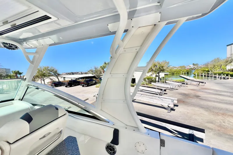 Slide: The Image of 2023 Chaparral 300 OSX boat interior with sleek design and waterfront view. - 19