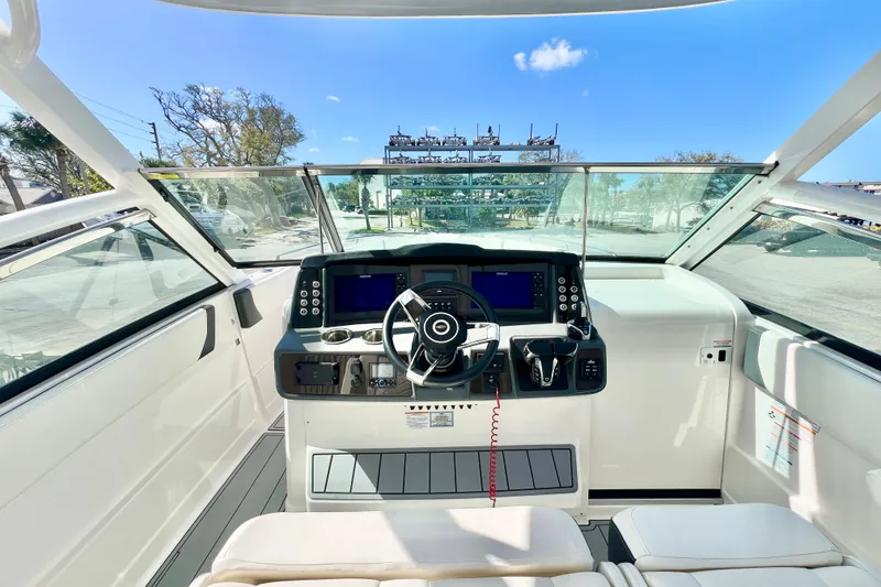 Slide: The Image of 2023 Chaparral 300 OSX boat cockpit with modern steering and navigation controls. - 20