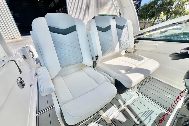 Slide: The Image of 2023 Chaparral 300 OSX boat interior with luxurious white seating and modern design. - 21