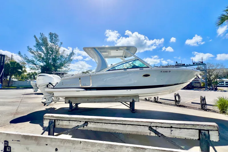 Slide: The Image of 2023 Chaparral 300 OSX boat on display under a clear blue sky. - 3