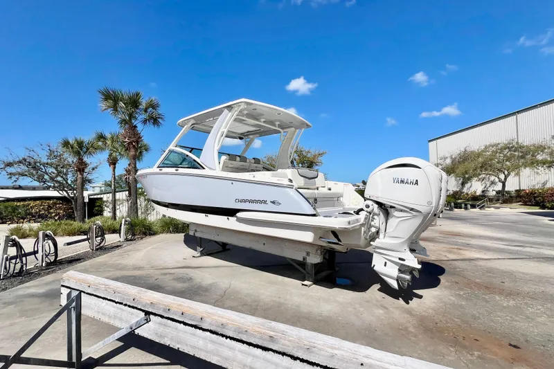 Slide: The Image of 2023 Chaparral 300 OSX boat with Yamaha engine on display under clear blue sky. - 6
