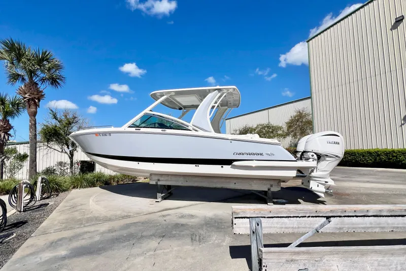 Slide: The Image of 2023 Chaparral 300 OSX boat on display, featuring sleek design and Yamaha engines. - 7