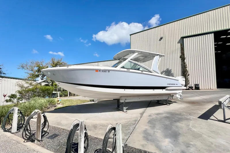 Slide: The Image of 2023 Chaparral 300 OSX boat on display outside a large warehouse. - 9