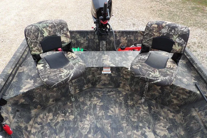 Slide: The Image of 2018 Crestliner 1660 Retriever boat with camouflage seats and interior design. - 10