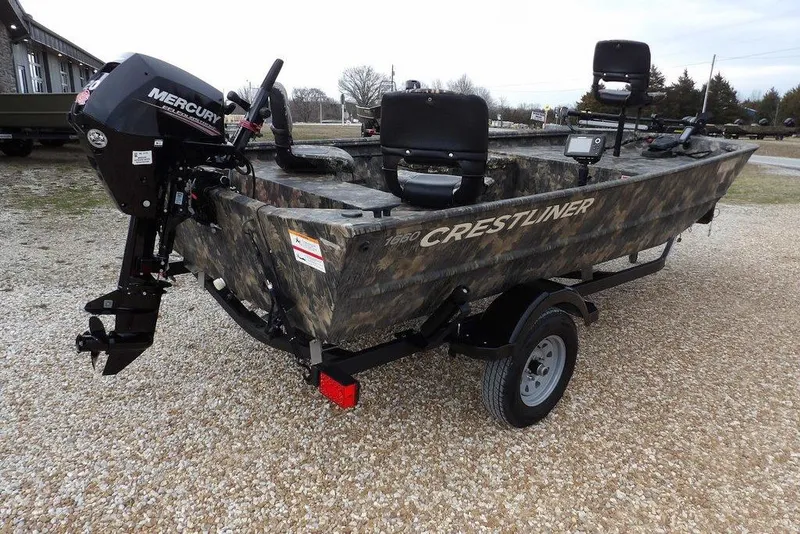 Slide: The Image of 2018 Crestliner 1660 Retriever boat with Mercury engine on gravel surface. - 11