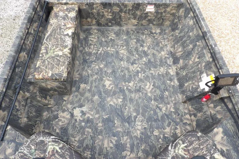 Slide: The Image of 2018 Crestliner 1660 Retriever boat interior with camouflage pattern and seating. - 12
