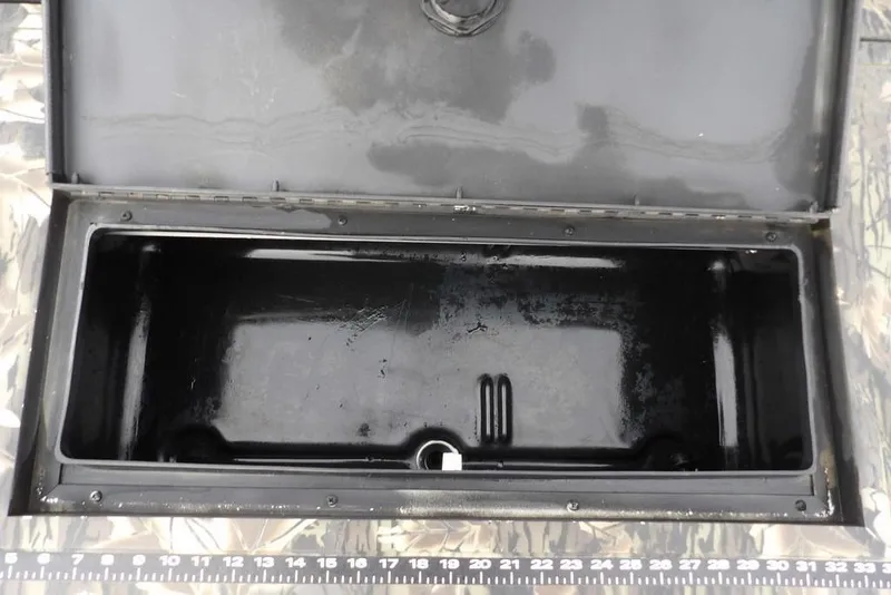 Slide: The Image of Open storage compartment of 2018 Crestliner 1660 Retriever boat, with measuring scale. - 13