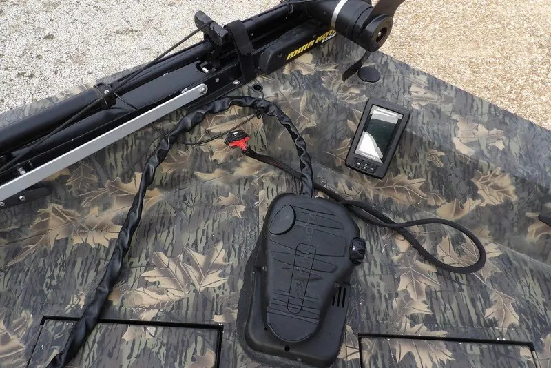 Slide: The Image of 2018 Crestliner 1660 Retriever boat with camo pattern, trolling motor, and fish finder. - 19