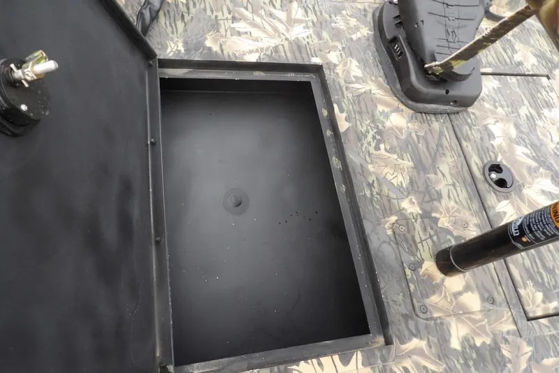 Slide: The Image of 2018 Crestliner 1660 Retriever boat with open storage compartment and camouflage deck. - 21