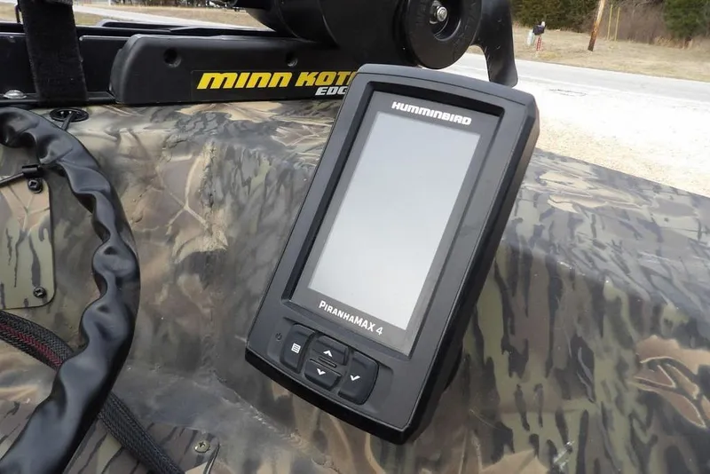 Slide: The Image of Fishfinder on 2018 Crestliner 1660 Retriever boat with camo pattern and Minn Kota motor. - 24