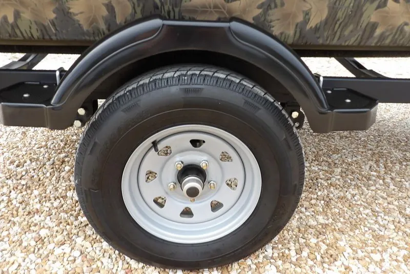 Slide: The Image of 2018 Crestliner 1660 Retriever trailer wheel on gravel surface. - 34