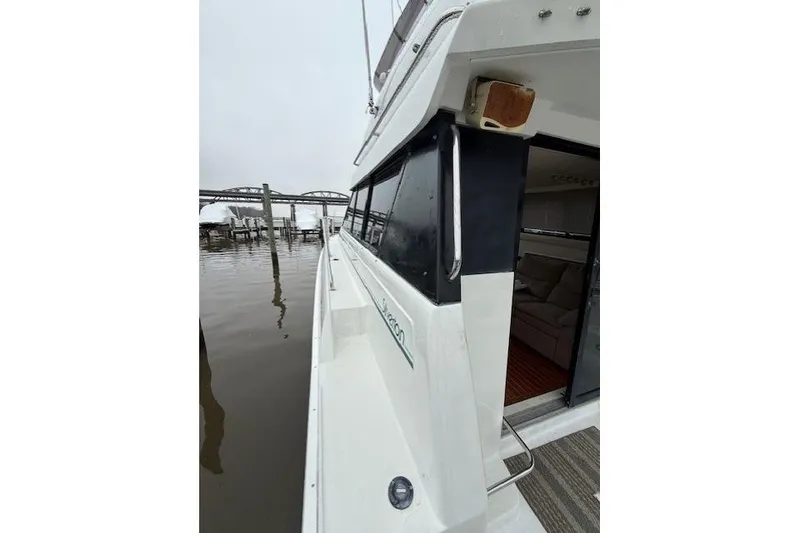 Slide: The Image of 1993 Silverton 34 Convertible yacht docked, showcasing sleek design and spacious interior. - 10