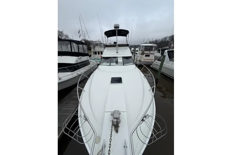 Slide: The Image of 1993 Silverton 34 Convertible yacht docked at marina, front view. - 12