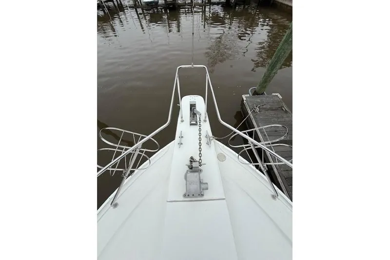 Slide: The Image of Bow view of 1993 Silverton 34 Convertible boat docked at marina. - 17