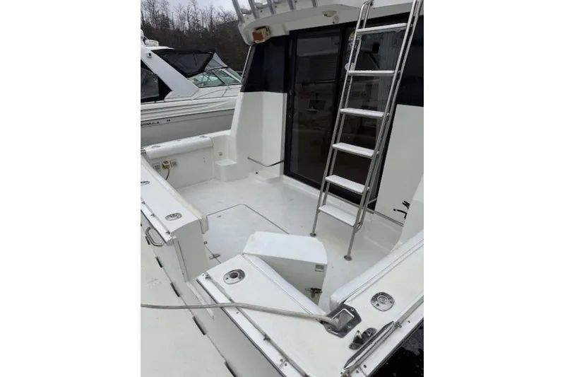 Slide: The Image of 1993 Silverton 34 Convertible boat deck with ladder and seating area. - 18