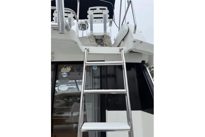 Slide: The Image of 1993 Silverton 34 Convertible yacht with ladder to upper deck. - 23