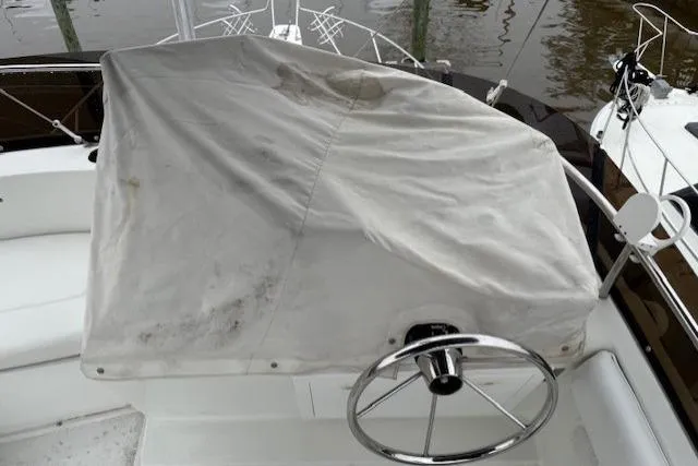 Slide: The Image of 1993 Silverton 34 Convertible boat helm covered with a protective tarp. - 25