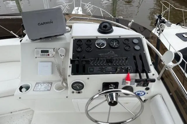 Slide: The Image of 1993 Silverton 34 Convertible boat helm with Garmin navigation system and control panel. - 26