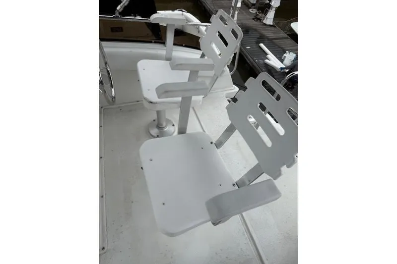 Slide: The Image of White captain's chairs on a 1993 Silverton 34 Convertible boat deck. - 29