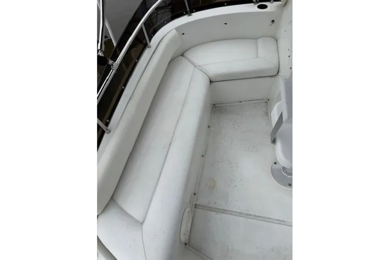 Slide: The Image of 1993 Silverton 34 Convertible boat interior with white seating and railing. - 30