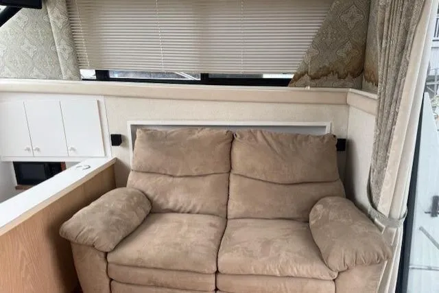 Slide: The Image of 1993 Silverton 34 Convertible interior with beige sofa and window blinds. - 33