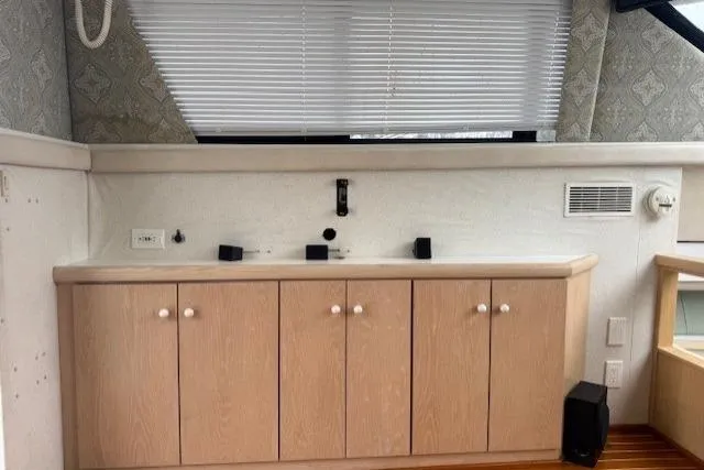 Slide: The Image of Interior of 1993 Silverton 34 Convertible yacht with wooden cabinets and blinds. - 34