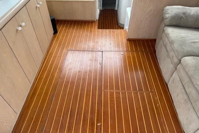 Slide: The Image of 1993 Silverton 34 Convertible interior with wooden flooring and beige cabinetry. - 35