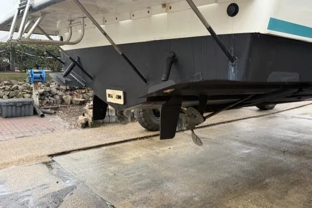 Slide: The Image of 1993 Silverton 34 Convertible boat hull and propeller in dry dock. - 4