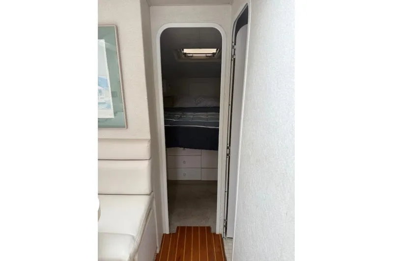 Slide: The Image of Interior view of 1993 Silverton 34 Convertible yacht cabin with bed and storage. - 44
