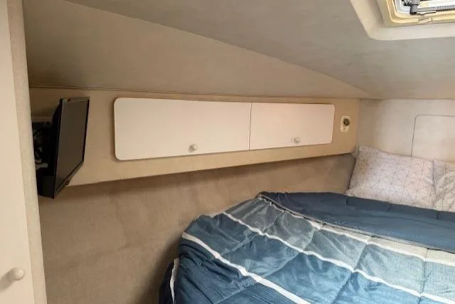 Slide: The Image of Cozy cabin interior of 1993 Silverton 34 Convertible with bed and storage cabinets. - 46