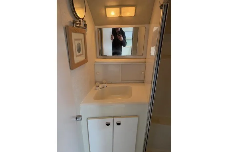 Slide: The Image of 1993 Silverton 34 Convertible bathroom with sink, mirror, and cabinet. - 49