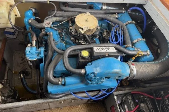 Slide: The Image of Engine of a 1993 Silverton 34 Convertible boat, featuring blue components and hoses. - 54