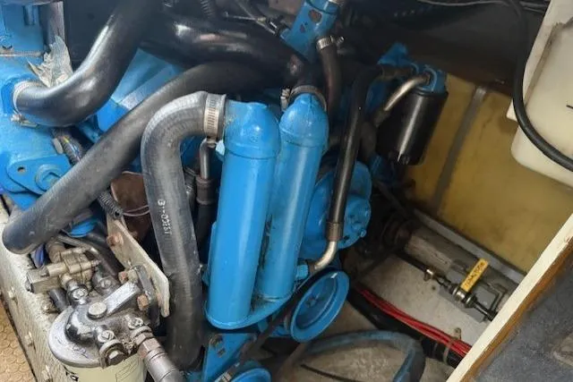 Slide: The Image of 1993 Silverton 34 Convertible engine compartment with blue components and hoses. - 55